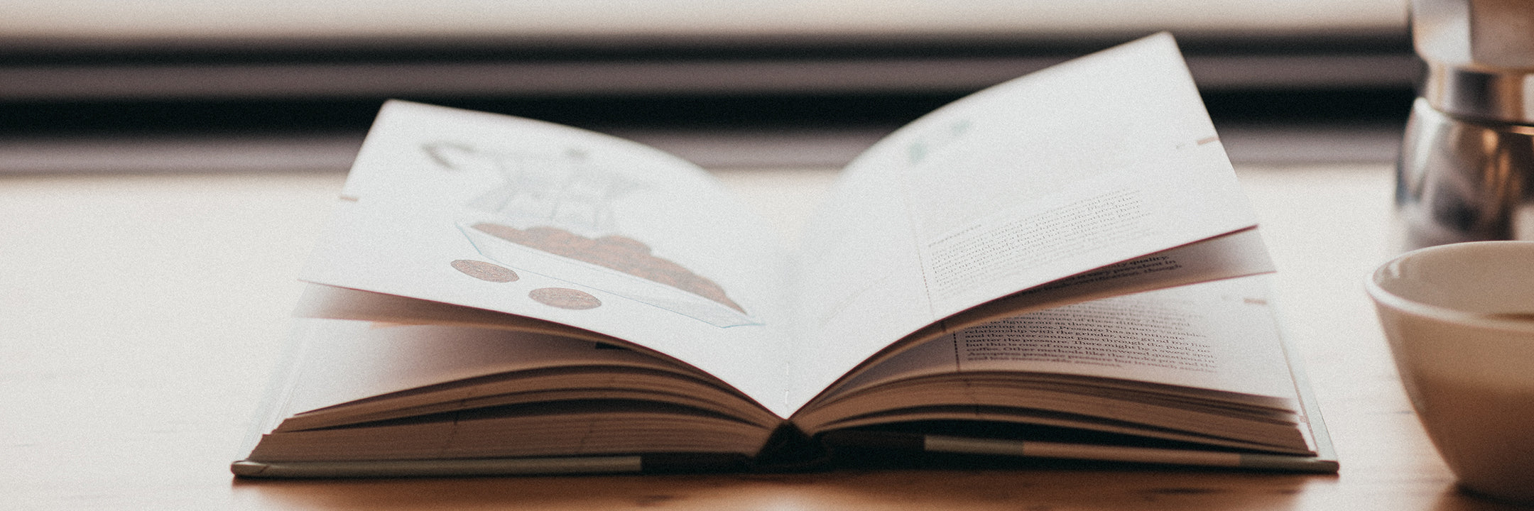 Book open with cup of coffee